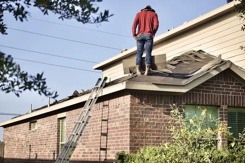 Professional roofer working on a residential roof in North Dansville